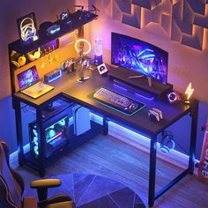 a computer desk with a keyboard and mouse on it in front of a wall decorated with neon lights