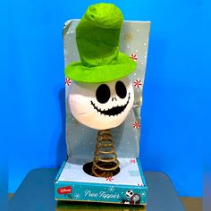 a jack - o'- lantern with a green hat on top of a box