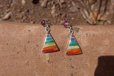 This beautiful earring is handmade by the beautiful Quechua people of the Peruvian Andes. It is made by silver and natural semiprecious gemstones and sacred shells of the region.(crystacola / peruvian turquiose, lapiz azul, spondillus, mother of pearlWeight : 4.7 grWidth : 1.5 cmHeight : 1.9 cmHeight with hook : 3.3 cmIt is handmade in 950 silver with inlaid stone and shell by a local family of jewelry artesians. Bohemian Sterling Silver Gemstone Earrings, Bohemian Multicolor Multi-stone Earrings, Bohemian Sterling Silver Earrings With Natural Stones, Handmade Rainbow Sterling Silver Earrings, Southwestern Natural Stone Earrings For Gifts, Southwestern Style Earrings With Natural Stones For Gifts, Bohemian Multicolor Pendant Earrings, Bohemian Multi-stone Dangle Earrings, Bohemian Multicolor Gemstone Earrings