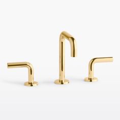 two gold faucets on a white background