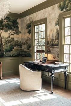 a living room filled with furniture and a painting on the wall next to a window