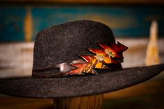 Our hand-tooled leather hat band is perfect for anyone who loves unique and eye-catching style. It features a dead-themed, 13-point lightning bolt shape in shades of brown and black. The real showstopper is the hand-carved design of the Azurescens mushroom, carefully tooled into the leather. Each hat band is one-of-a-kind due to the variations in the tooling process. Our leather hat band is not only stylish but also comfortable to wear. The soft, goatskin leather ties can be tied at any length, Hat Bands, Mushroom Hat, Leather Hat, Mushroom Design, Leather Hats, Shades Of Brown, Hand Tooled Leather, Tooled Leather, Hat Band