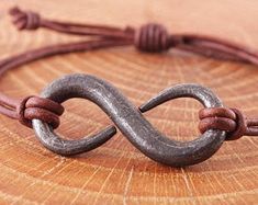 a close up of a metal object on a wooden surface with a string attached to it