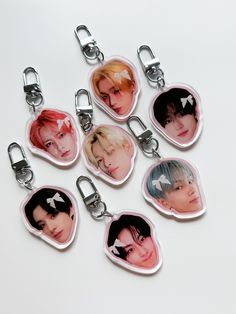 six keychains with different images of the same person on them, all in various shapes and sizes