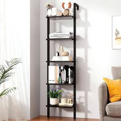 a living room filled with furniture and a book shelf next to a couch on top of a hard wood floor