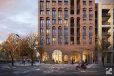 a scooter is parked in front of a brick building with arched doorways