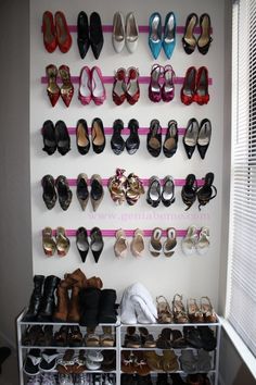 there are many pairs of shoes hanging on the wall