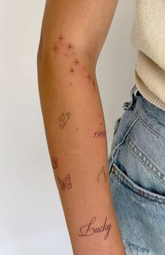 a woman's arm with tattoos on it and the word buddy written in cursive writing