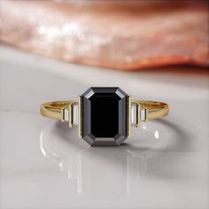 a black diamond ring sitting on top of a table