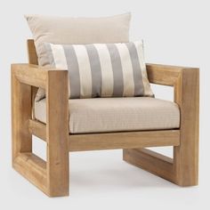 a wooden chair with a striped pillow on it's back and armrests