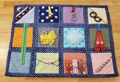 there is a patchwork table mat with scissors and other items on it that are sitting on the floor