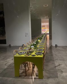 a long table is set up with plates and place settings for an event or gathering