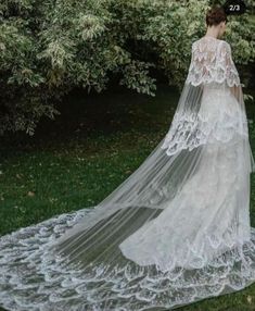 a woman in a wedding dress with a long veil