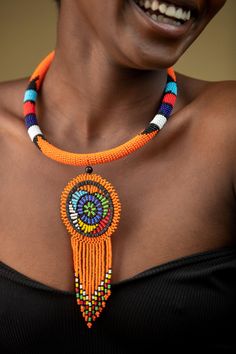 Unique African Maasai Handcrafted Beaded Necklace with an Elegant Look and Brilliant Finish. **GET FREE SHIPPING FOR ADDITIONAL ITEMS PURCHASED. Yes, Buy Multiple Items and pay shipping for 1 item only- The rest ships Free. (No Limits on the number of Multiple items). With a faster delivery time of 3 days via DHLExpress, Worldwide. Ordinary/Standard Shipping also available upon request. We Custom Make to Suit Your Taste. Available In All Colors and Sizes. For wholesale please chat me up for disc Orange Beaded Chain Necklace For Festival, Traditional Orange Beaded Chain, Traditional Orange Necklaces With Dangling Beads, Bohemian Beaded Round Choker, Traditional Orange Necklace With Dangling Beads, Traditional Orange Beads For Festival, Orange Bohemian Beaded Necklaces With Round Shape, Artisan Orange Beaded Necklaces, Unique Orange Necklace For Festivals