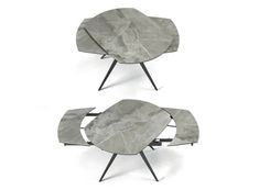 two tables made out of marble with metal legs and one has a circular shaped table top