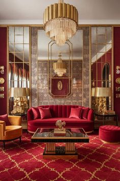 a living room filled with red couches and gold mirrors on the wall above them