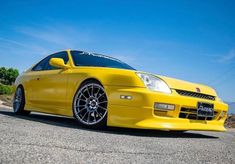 a yellow sports car parked on the street