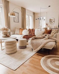 a living room filled with furniture and lots of windows