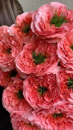 a bunch of pink flowers sitting on top of a table