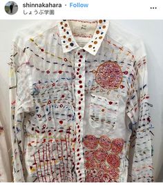 a white shirt with colorful designs on it