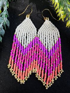 These handwoven pinktastic seed beaded earrings are so fun and vibrant. They are made with beige, pink, purple orange and gold plated Miyuki beads of the highest quality. Who doesn't love an all pink outfit! Wear these fringe dangle earrings for a night out with your girlfriends and you'll surely love the attention. These earrings are packed in a chic cloth bag and can be gifted to your girl gang.  Each pair of earrings are crafted to order. All the earring hooks are nickle free and hypoallergen Pink Tiny Beaded Earrings, Pink Bohemian Beaded Earrings, Bohemian Pink Beaded Earrings, Festival Pink Beaded Jewelry, Pink Beaded Jewelry For Festival, Handmade Pink Beaded Earrings For Beach, Pink Teardrop Earrings For Beach, Bohemian Pink Beaded Earrings With Tiny Beads, Pink Dangle Beaded Earrings For Festival