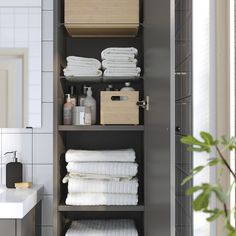 the shelves in this bathroom are filled with towels and other things to put on them