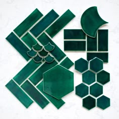 green glass tiles laid out on top of each other in different shapes and sizes,