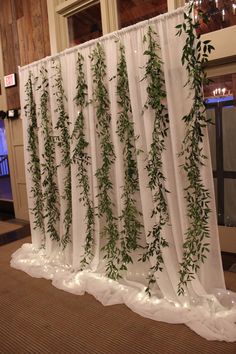 the curtain is decorated with green plants and lights