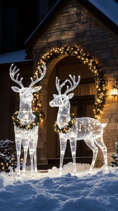 Outdoor Christmas decorations featuring white LED lights, reindeer statues, garlands, and wreaths in a snowy setting at Lighted Reindeer Outdoor Christmas, Outdoor White Christmas Decor, Decor With Lanterns, Outdoor Reindeer, Reindeer Statue, Christmas Lights Outside, 2025 Christmas, Reindeer Lights