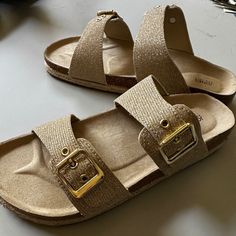 Tan, Gold Glitter Straps, Cork And Raffia Sole. New With Box, Never Worn, Just Tried On Indoors. Bought When Store Labeled Them As My Size, But They Are A 9. Straps Buckle And Are Adjustable Wider Or Narrower. Comfortable Gold Synthetic Sandals, Casual Gold Footbed Sandals For Beach, Gold Textured Footbed Sandals For The Beach, Comfortable Gold Open Toe Sandals, Gold Synthetic Footbed Sandals With Round Toe, Casual Gold Open Toe Footbed Sandals, Gold Cushioned Footbed Sandals For Beach, Gold Synthetic Round Toe Footbed Sandals, Casual Glitter Sandals With Synthetic Material