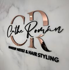 the sign for the hair styling salon is shown in black and rose gold