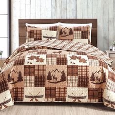 a bed covered in a brown and white plaid comforter with moose on the side