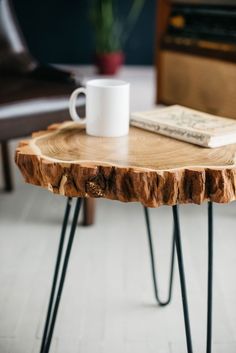 a coffee table with hairpin legs and a book on it's end stand