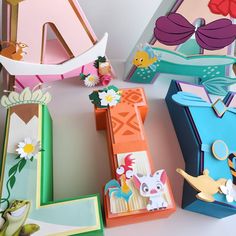 the letters are made out of paper and decorated with flowers, birds, and other things