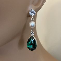 Long Green Earrings Emerald Green Rhinestone Earrings Pear Shape with Swarovski Pearl wedding bridal jewelry These Bridal Earrings in Emerald Green Crystal Rhinestone are so pretty with a Long Green Pear Shaped Drop that measures a total of 2 inches long. Made with a Swarovski Pearl in your choice of color either White (shown) or Cream Ivory, these also have a CZ Rhinestone post on the top. Comes in a Gift Box and ready to give. Perfect wedding bridal or gift! To see more Bridal Wedding Jewelry Green Teardrop Pearl Earrings For Wedding, Green Crystal Rhinestone Earrings For Wedding, Green Rhinestone Crystal Earrings For Wedding, Wedding Green Crystal Rhinestone Earrings, Green Crystal Bridal Earrings For Wedding, Elegant Green Crystal Earrings For Weddings, Emerald Green Crystal, Emerald Green Earrings, Earrings Emerald