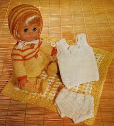 an old knitting pattern for a doll with clothes on the floor, and a baby's diaper