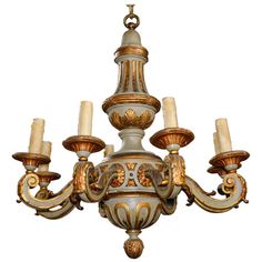 an ornate chandelier with five candles hanging from it