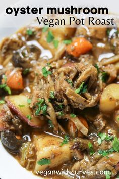 a close up of a bowl of food with mushrooms and carrots in it on a white plate