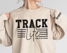 Customize this track mom shirt to meet your needs! Choose from short sleeve, long sleeve, hoodies, and crewneck sweatshirts and add your team / mascot and your name / number! Other color options and styles are available. If you don't see what you're looking for send us a message! The shirts are a UNISEX retail fit - they are more of a relaxed fit and may run a little large on women and those with a smaller frame . Make sure to see the size charts (last images) to confirm the best fit for you. We Track Shirts Designs Mom, Track Shirts Designs Ideas, Track Mom Shirts Ideas, Track Shirts Designs, Track And Field Outfits, Track Shirts, Athletic Wallpaper, Cross Country Shirts, Track Mom