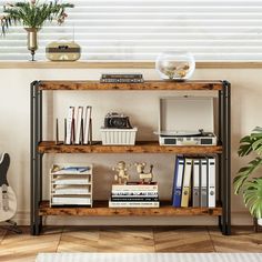 a bookshelf with various items on top of it in front of a window