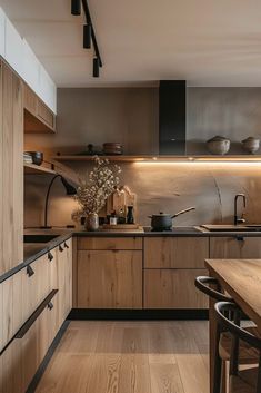 a kitchen with wooden cabinets and counter tops, along with an island in the middle