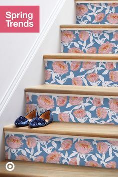 the steps are decorated with floral wallpaper and blue slippers, along with pink flowers