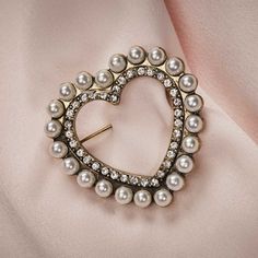 Introducing our exquisite Heart Pearl Brooch, a perfect gift for someone who appreciates the elegance of pearl jewellery and the finer things in life. This stunning 1950s-inspired piece features a beautiful heart-shaped pearl, adorned with dazzling diamanté. It is designed to be worn close to the heart and's a timeless accessory that will remind your loved one of you every day. With its simple yet captivating design, this brooch is meant to be cherished. This pearl brooch pin was beautifully han Brooches Jewelry, Emerald Earrings Drop, Blue Drop Earrings, Heart Shaped Jewelry, Love Shape, Pearl Jewellery, Heart Brooch, Long Drop Earrings, Brooch Jewelry