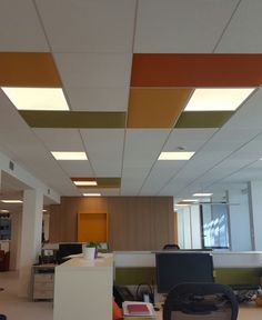 an empty office with desks and computers