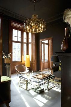 a living room filled with furniture and a chandelier