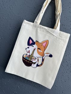 Ramen Calico Kitty Canvas Tote Bag Chibi/Funko Style Demon Sister Cream Color High Quality Tote  Product Description: -Individually DTF Pressed  -Durable /High Quality Tote Bag  -Product size :12.2*14.2 inches (31*36cm) -Cream Colored Great for grocery shopping , outdoor events, beach bag or trendy collectable gift. These reusable bags are made of polyester material, environmentally friendly and non-toxic, easy to fold and put away when not in use, and can be reused to avoid the pollution caused by using disposable paper and plastic bags. **Disclaimer: All sales are final due to the nature of the item. All items are uniquely made/placed by hand , minor defects may occur.  Once the item(s) ships, I have no control over the time it arrives to you.  Tracking information is provided as soon as Cat Eating, Unique Tote Bag, Color Crema, Trendy Tote Bags, Eco Bag, Cute Little Drawings, Trendy Tote, Plastic Bags, Outdoor Events