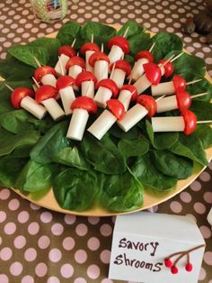 a plate with toothpicks and spinach leaves on it sitting on a table