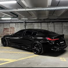 a black sports car parked in a parking garage