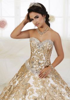 Look unforgettable in this floral sequined A-line dress by House of Wu Quinceanera Collection 26909 during your Quinceanera, Sweet 16 party, or for any formal event. This princess ball gown features a decorative floral sequin pattern. The strapless bodice is accented with statement beading around the sweetheart neckline and waist. This look is finished with lace up back. House of Wu Quinceanera Collection Fall 2018 Style Number: 26909 Fabric: Floral Sequins Colors: Black Gold/Champagne, Gold/Cha Fitted Sequined Quinceanera Dress For Gala, Quinceanera Gown With Sequins And Fitted Bodice, Elegant Sequined Quinceanera Dress For Gala, Sequin Fitted Quinceanera Dress For Debutante Ball, Embellished Ball Gown For Quinceanera Gala, Glamorous Embellished Quinceanera Dress For Gala, Embellished Ball Gown Quinceanera Dress For Gala, Fitted Sequin Quinceanera Dress, Embellished Ball Gown For Gala Quinceanera Dress