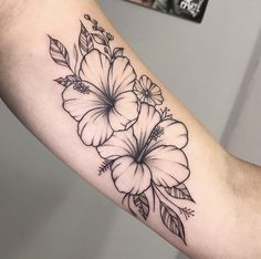 a black and white flower tattoo on the arm